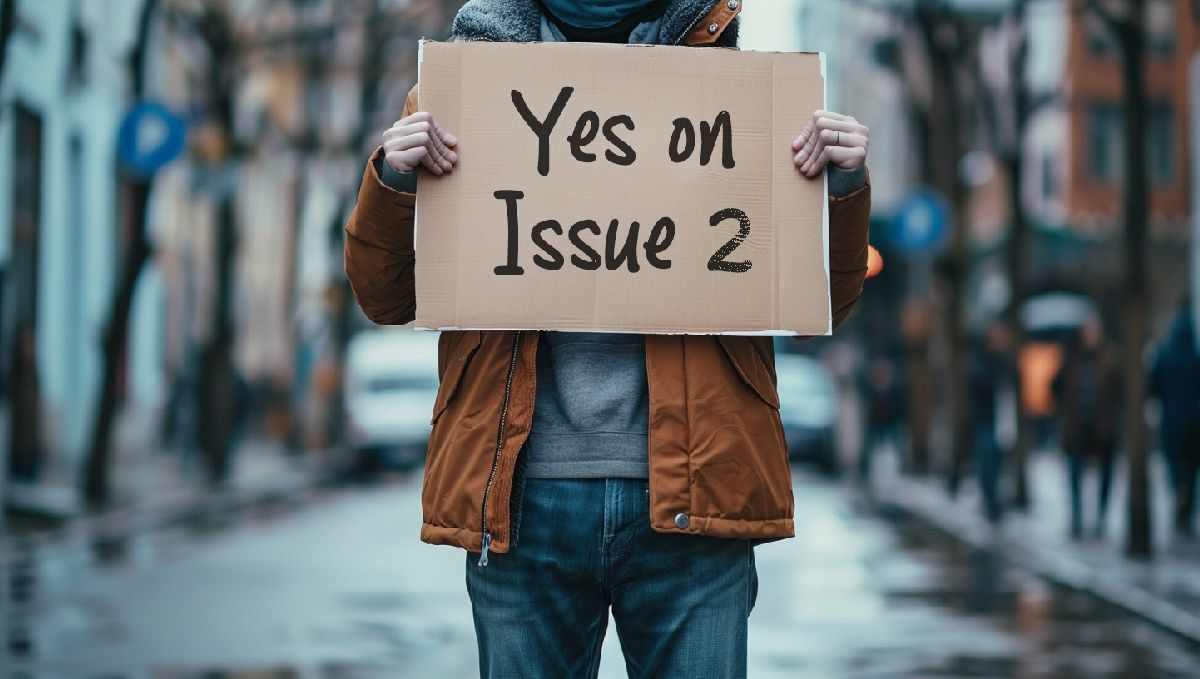 Weed in Ohio: Cannabis Legal Status Guide: A man in the street holding a Yes on Issue 2 sign